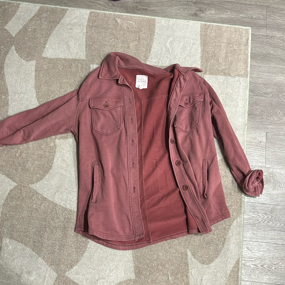 Red button down. It’s a little lighter than a shacket. Size L.